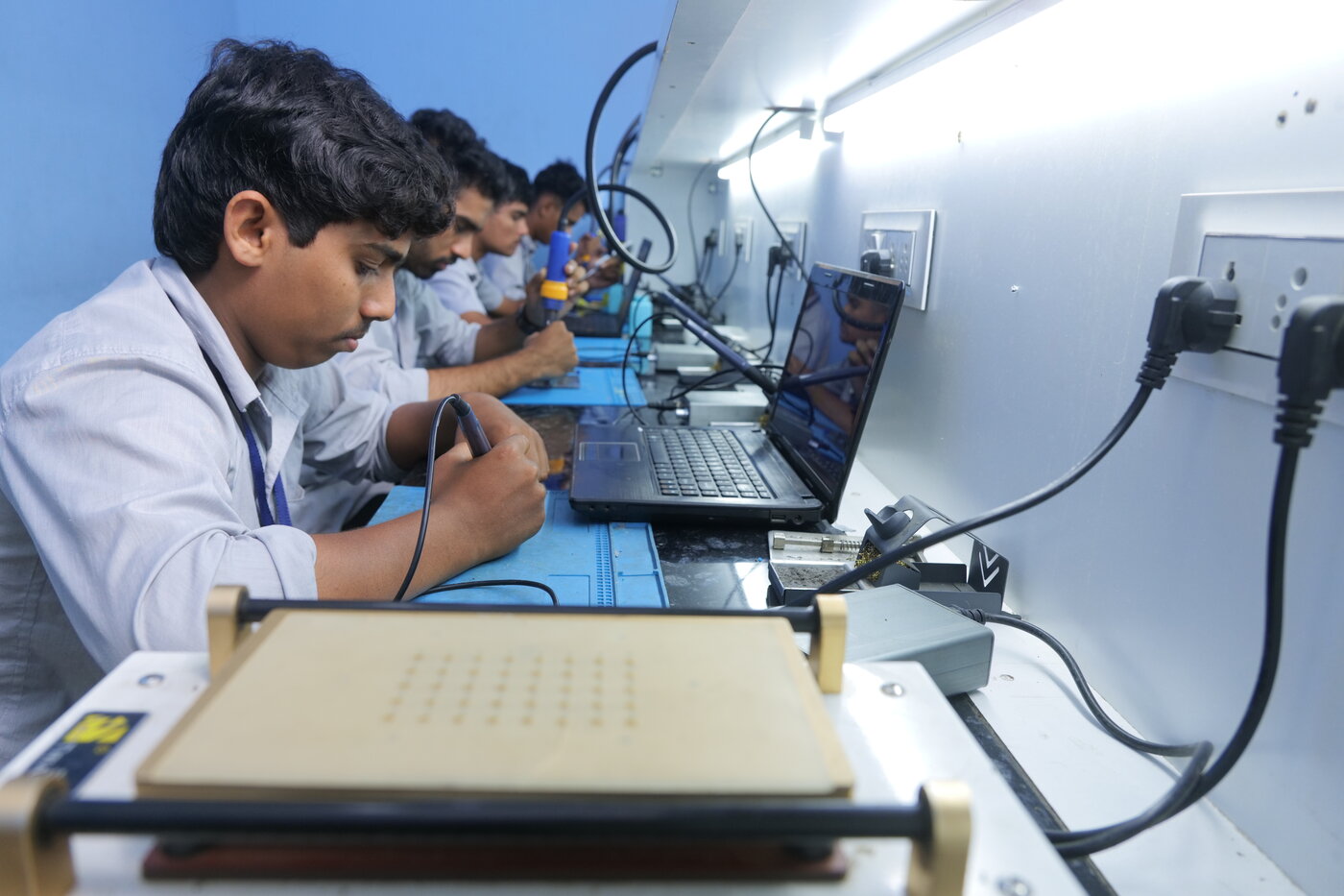 Students working at chip-level rework stations