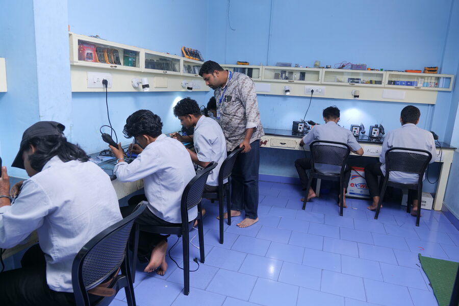 Students soldering at the electronics lab benches