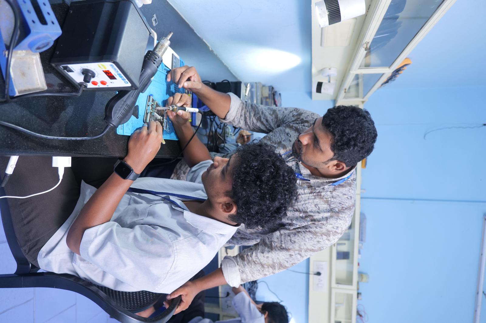 Instructor guiding student at chip repair station